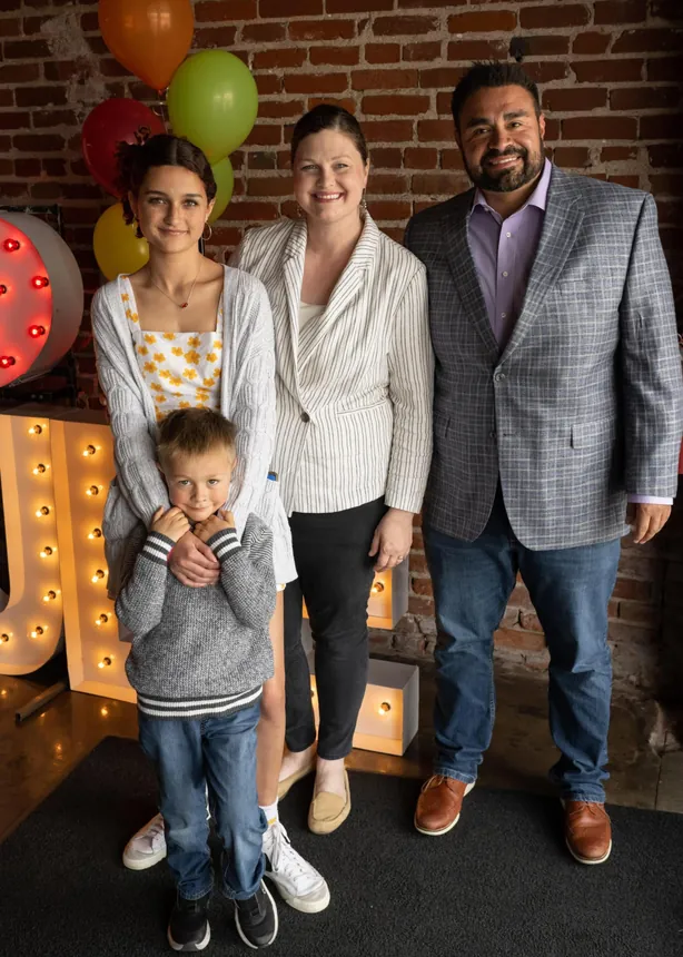 Nolan and Laura Henderson, owners of Poo Squad Lawrence, with family