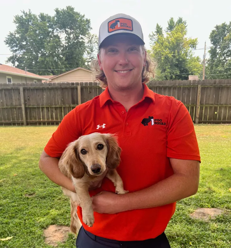 Tony Miller, owner of Poo Squad Wichita, with a dog