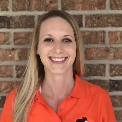 Ashley Coones, Poo Squad co-founder, in an orange Poo Squad shirt