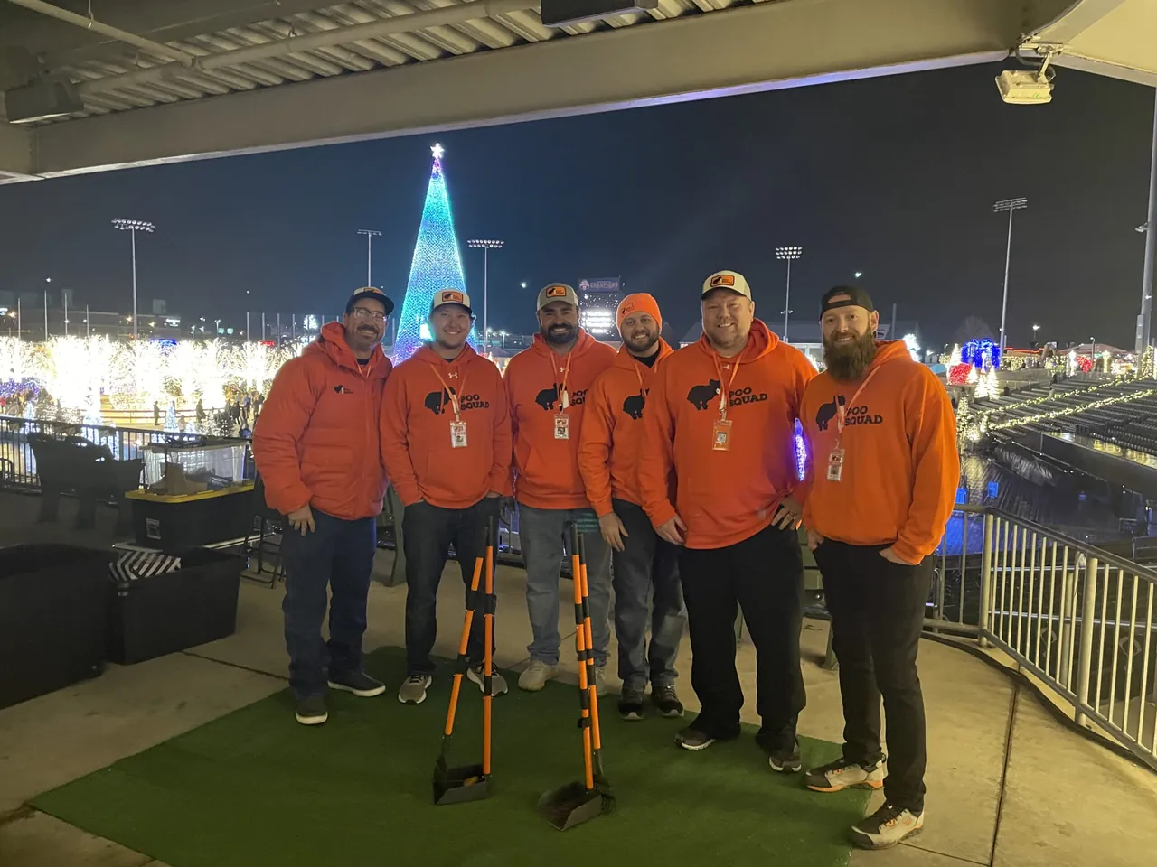 The Poo Squad team in orange at an outdoor event