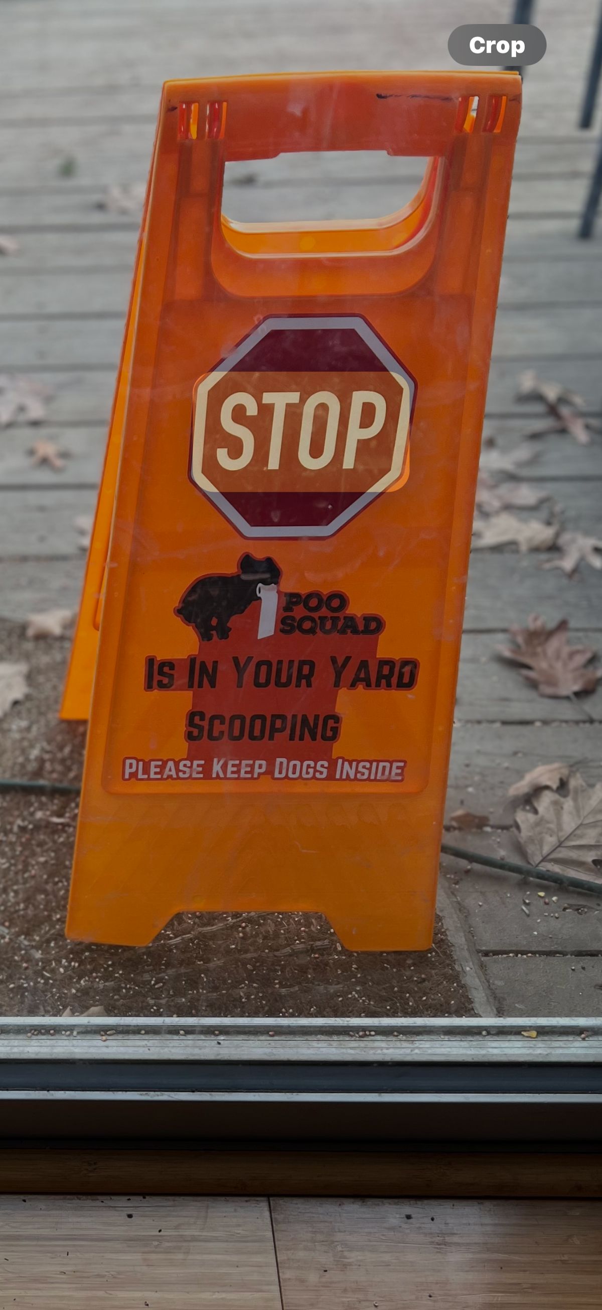 Orange Poo Squad sign on a leafy deck asking owners to keep dogs inside during scooping